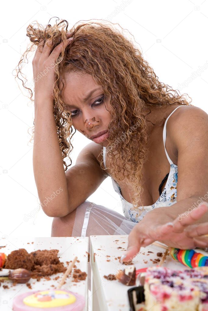 Pretty black girl pushing away the food that she has just eaten