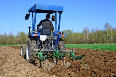 tractor plowing the field at spring 