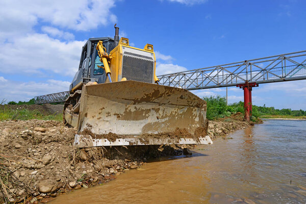bulldozer on the construction of a protective dam