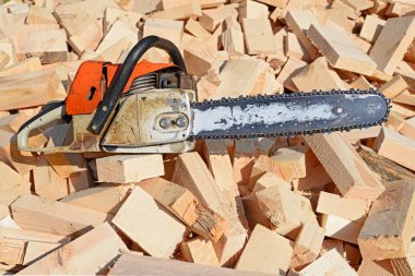 a closeup shot of wooden blocks and chainsaw