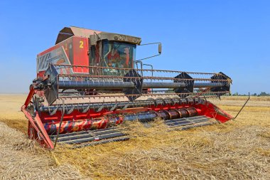 combine harvester working at wheat field, harvesting in the countryside