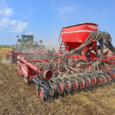 Kalush, Ukraine - August 10 : Modern John Deere tractor with a planter in the field near the town Kalush, Western Ukraine August 10, 2014