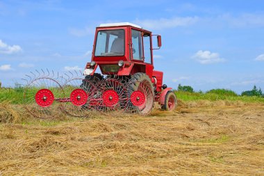 Dolyna, Ukraine - June 1, 2018: Harvesting hay in the fields of organic farm near the town Dolyna, Western Ukraine.