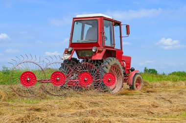 Dolyna, Ukraine - June 1, 2018: Harvesting hay in the fields of organic farm near the town Dolyna, Western Ukraine.