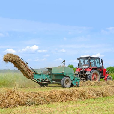 Dolyna, Ukraine - June 1, 2018: Harvesting hay in the fields of organic farm near the town Dolyna, Western Ukraine.