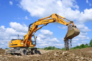Kalush, Ukraine - July 8: Loading boulders in the car body on the construction of a protective dam near the town of Kalush, Western Ukraine July 8, 2015