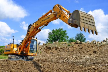 Kalush, Ukraine - July 8: Loading boulders in the car body on the construction of a protective dam near the town of Kalush, Western Ukraine July 8, 2015