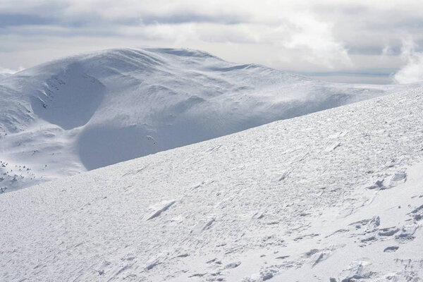 Winter on a hillside in a mountain landscape.