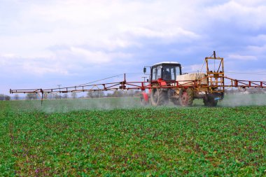 Kalush, Ukraine - May 30: Adding liquid fertilizer on the corn field with the young shoots near the town of Kalush, Western Ukraine May 30, 2015