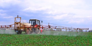 Kalush, Ukraine - May 30: Adding liquid fertilizer on the corn field with the young shoots near the town of Kalush, Western Ukraine May 30, 2015