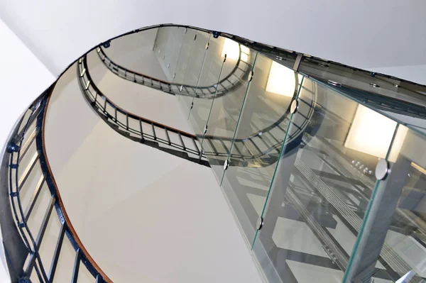 Stair well with a transparent elevator shaft in a modern building