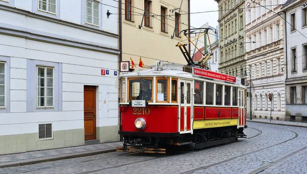 PRAGUE, CZECH REPUBLIC- November 30, 2016: Old tram on  old streets with tourists on the tour itinerary