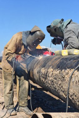 Welders on the pipeline repairs clipart