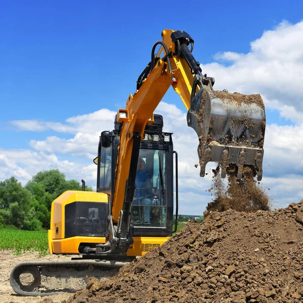 The modern excavator  performs excavation work on the construction site