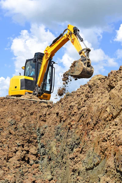 The modern excavator  performs excavation work on the construction site