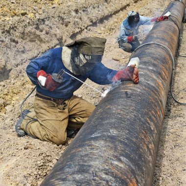 Welder on the pipeline repairs clipart