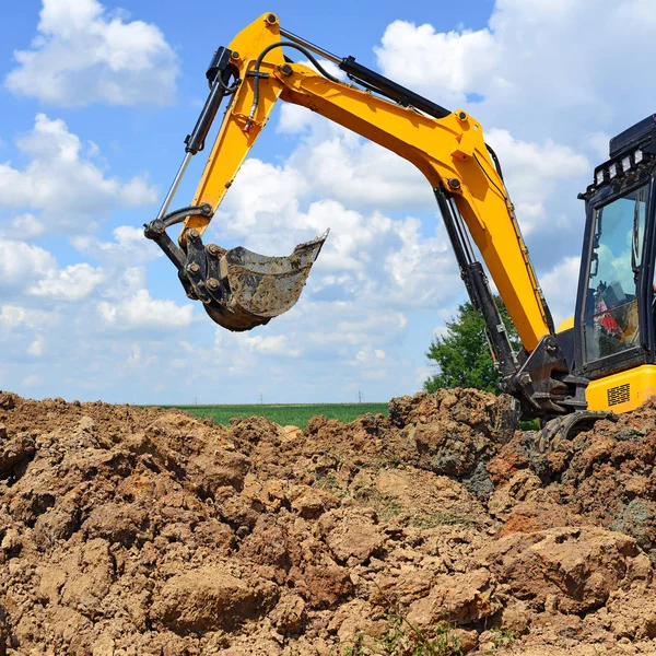 The modern excavator  performs excavation work on the construction site