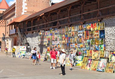 Krakow , Republic of Poland- July 3, 2017: Trade in painting near the fortress wall near St. Florian's Gate.