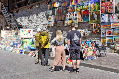 Krakow , Republic of Poland- July 3, 2017: Trade in painting near the fortress wall near St. Florian's Gate.