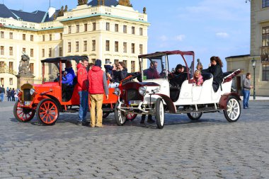 PRAGUE, CZECH REPUBLIC - May 7, 2017: Vintage cars foruring trips near Old Royal Palace