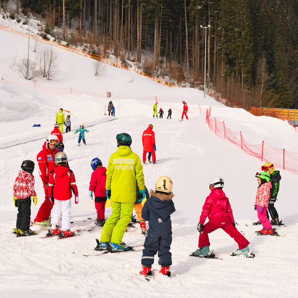 Ivano-Frankivsk region, Ukraine - February, 23, 2019: Ski instructors conduct classes with children on the playground.