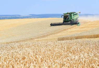 Kalush, Ukraine - OCTOBER 8: Modern combine harvesting in the field near the town Kalush, Western Ukraine October 8, 2013