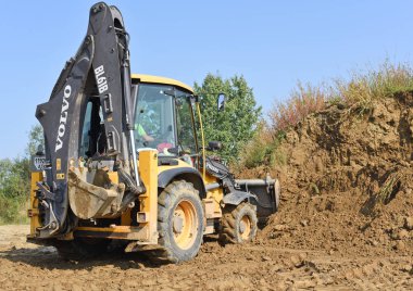 Kalush, Ukraine - August 18, 2018: Excavator on earthworks near the town of Kalush.