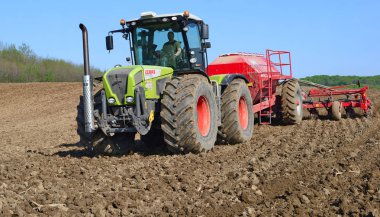 Kalush, Ukraine - OCTOBER 8: Modern combine harvesting in the field near the town Kalush, Western Ukraine October 8, 2013