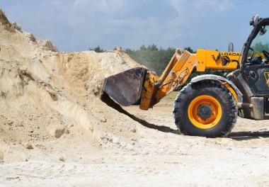 Kalush, Ukraine - August 18, 2018: Excavator on earthworks near the town of Kalush.