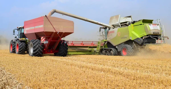 Kalush, Ukraine - OCTOBER 8: Modern combine harvesting in the field near the town Kalush, Western Ukraine October 8, 2013