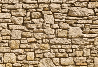 Fragment of a stone wall in a background photo. clipart