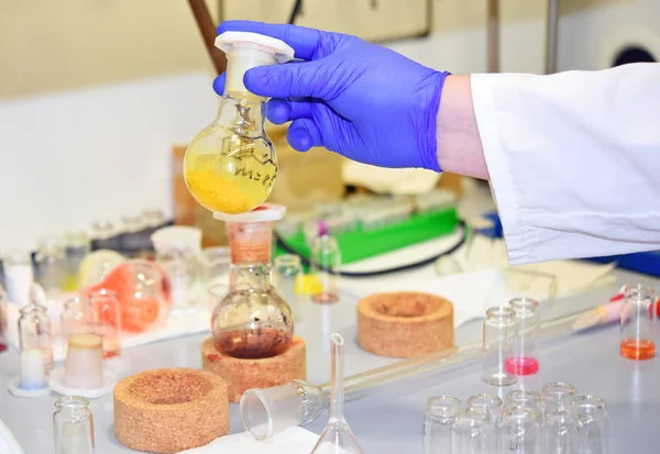 Flasks and bottles with new chemical compounds synthesized in laboratory.