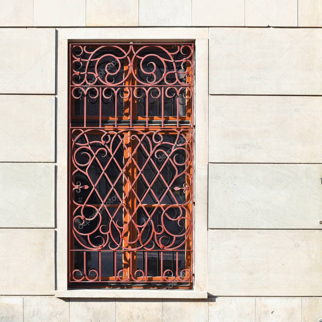 Window with a lattice of an ancient building. Old Wroclaw, 2019.
