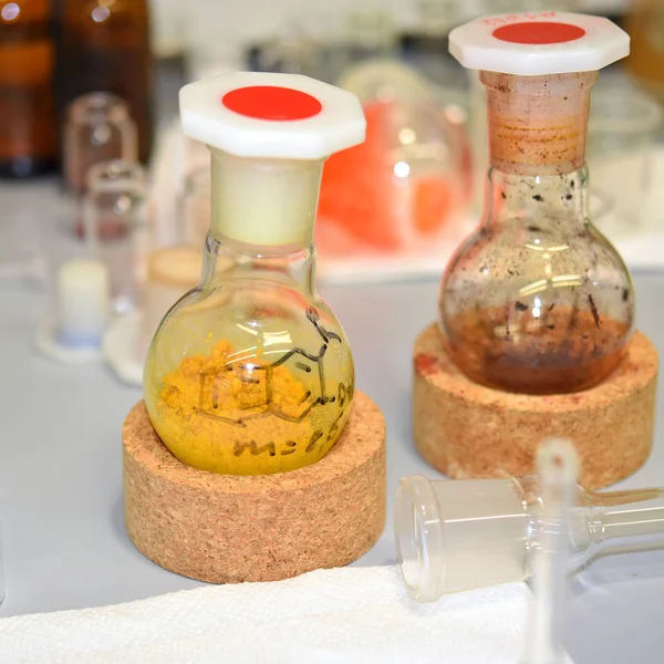 Flasks and bottles with new chemical compounds synthesized in laboratory.