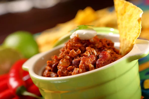 stock image Chili con carne with nachos on tablecloth in spanish patter