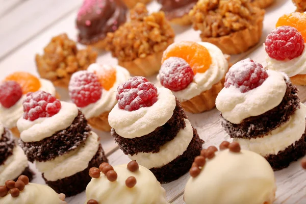 Catering sweets, closeup of various kinds of cakes on event or wedding receptio