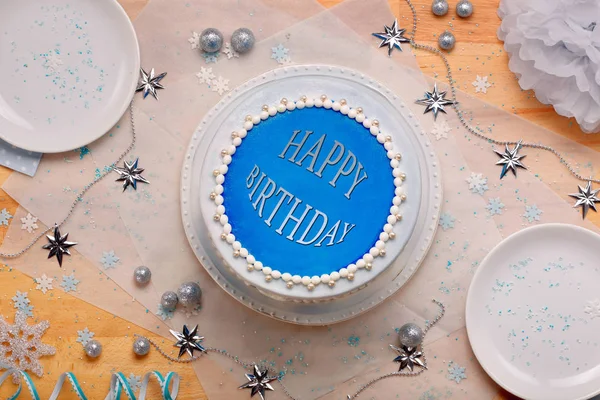 Blue cake with the happy birthday inscription