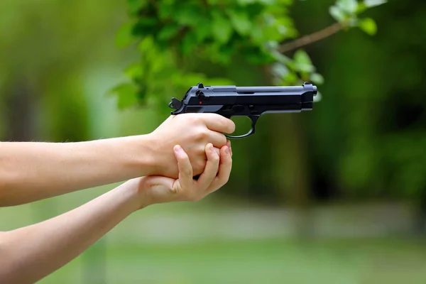 Young boy practice shooting guns on outdoo