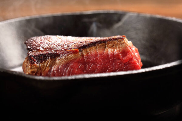 Juicy beef steak on cast iron skillet pan