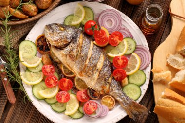 Roast Dorada on a wooden background