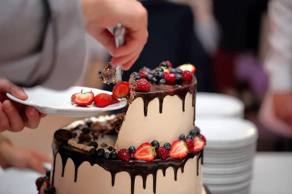 Tort weselny na imprezie i kelnerzy w tle — Zdjęcie stockowe
