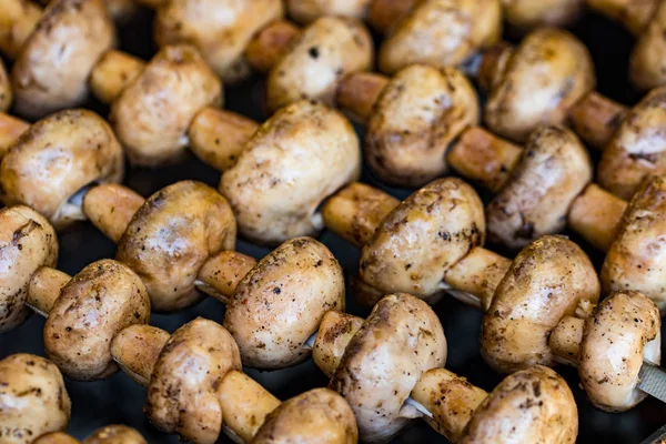 Izgara mantar ve şiş mantar. Daha az pişmiş, yakın plan..