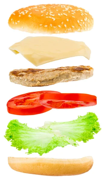 Heerlijk hamburger met vliegende ingrediënten op witte achtergrond — Stockfoto