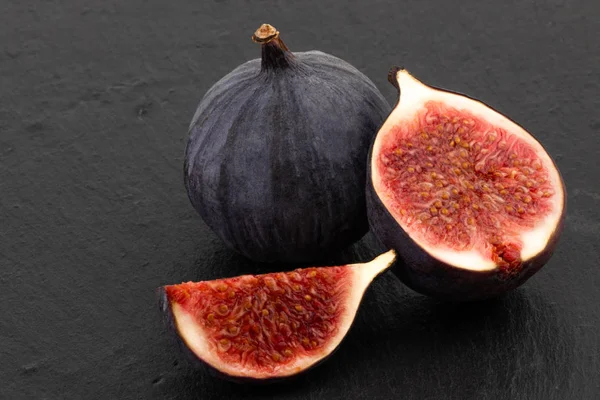 fresh ripe figs on dark background close up.