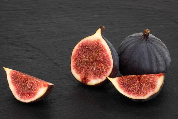 fresh ripe figs on dark background close up.