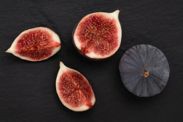 fresh figs on dark background, top view.