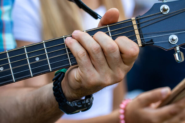 Close up of man hand playing guitar.Practicing in playing guitar.