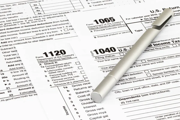 The tax forms with  money and the pen. Tax Day concept.
