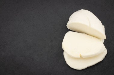Karanlık bir arka plan üzerinde Mozzarella peyniri. Kopya alanı ile Üstten Görünüm.