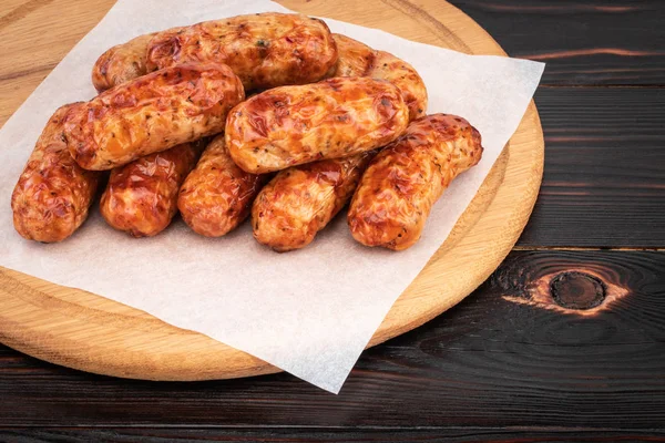 Tasty grilled sausage on the wooden background — Stock Photo, Image
